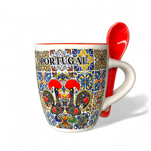 Colorful mug with 'Portugal' text and rooster design, featuring a red spoon on a white background.