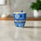 Ceramic mug with blue and white pattern and 'Portugal' text on a neutral background