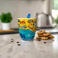 Colorful cup with a map design on a white surface