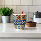 Colorful ceramic mug with 'Portugal' text on a plain background