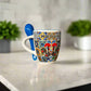 Colorful mug with 'Portugal' text and a blue spoon on a neutral background