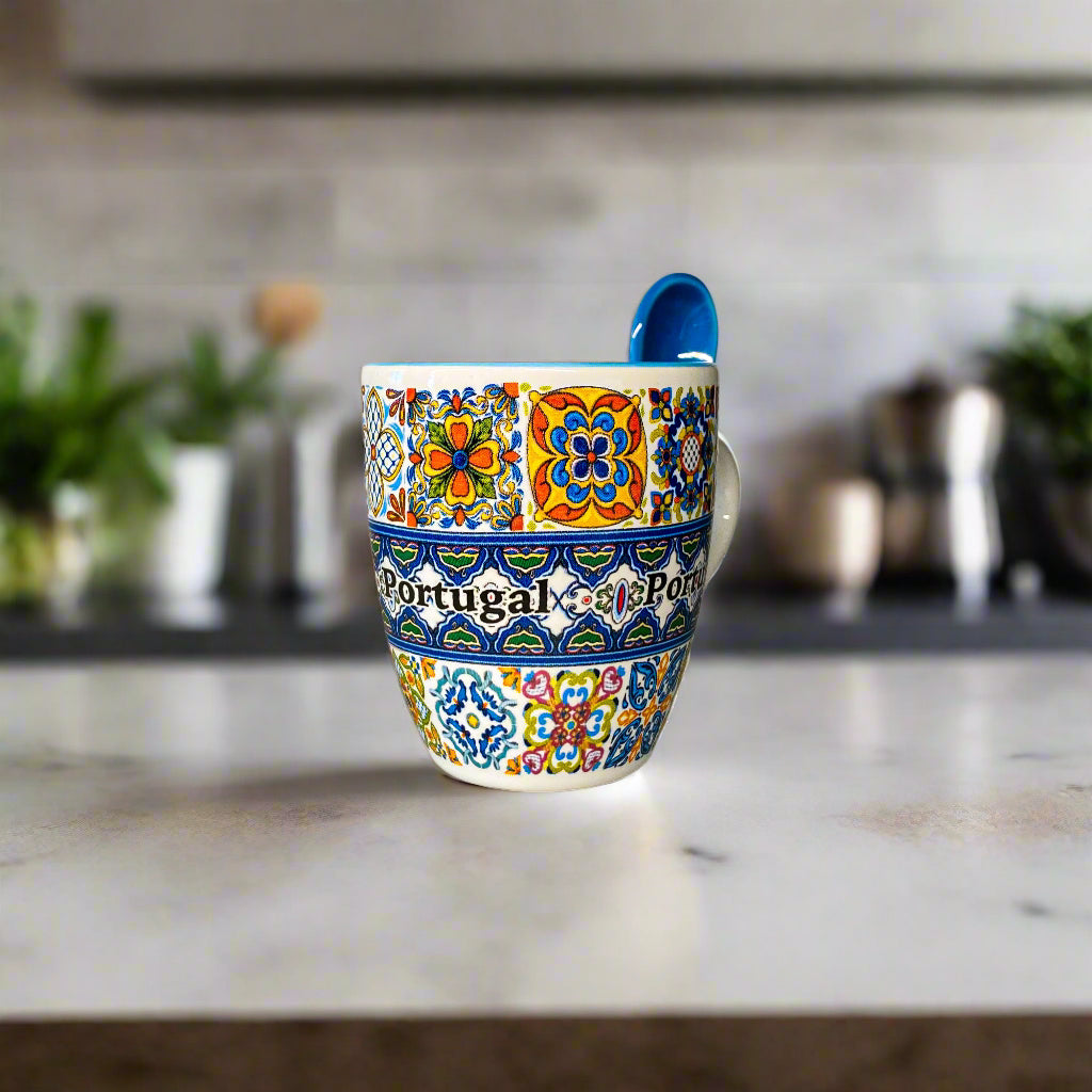 Colorful ceramic mug with floral patterns and 'Portugal' text on a neutral background