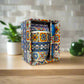 Decorative ceramic mug with colorful patterns in a box on a neutral background