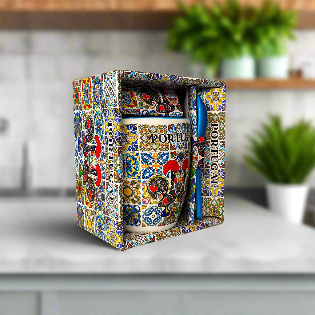Decorative mug with colorful patterns in a matching box on a light surface.