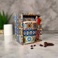 Colorful ceramic mug with 'Portugal' text in a decorative box on a table.