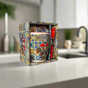 Decorative mug with colorful patterns and 'Portugal' text in a matching box on a light background
