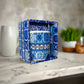 Ceramic mug with blue and white pattern and 'Portugal' text, placed in a decorative box.