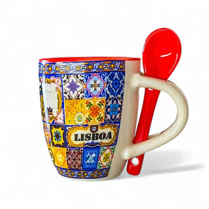 Colorful coffee cup with decorative patterns and a red spoon on a white background
