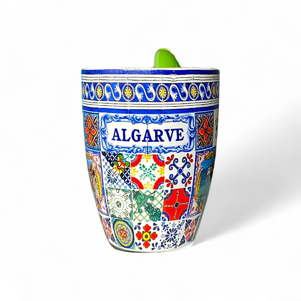 Ceramic Algarve souvenir mug decorated with colorful traditional Portuguese tile patterns and the word "Algarve" in blue, photographed on a white background.