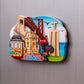 Fridge magnet with colorful illustrations of Lisbon landmarks on a gray background
