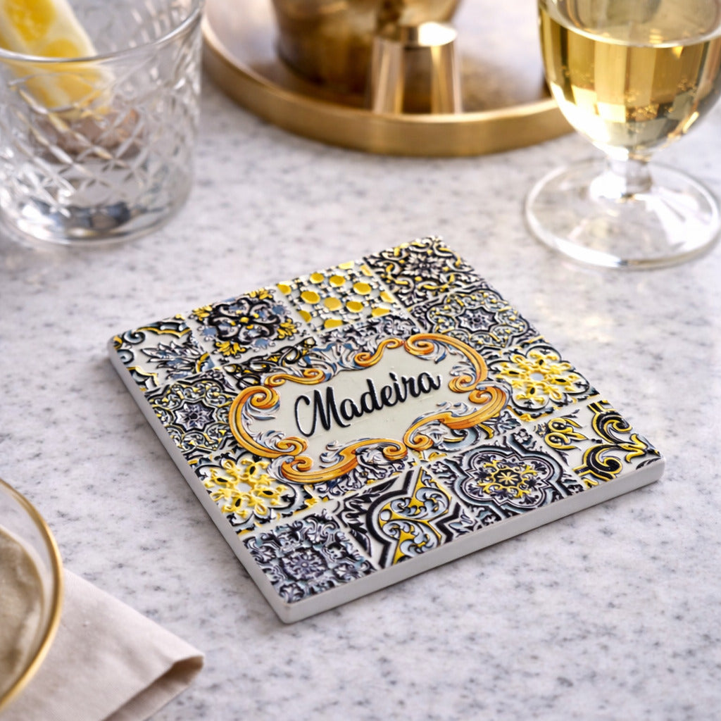op view of square Madeira ceramic coaster showing detailed tile patterns and central Madeira text