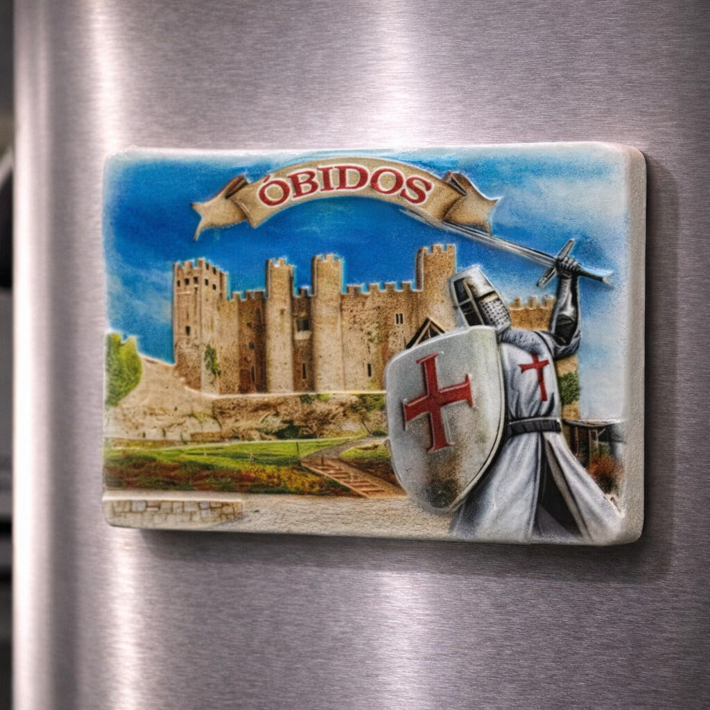Óbidos souvenir magnet placed on a fridge with illustrated medieval castle, warrior, shield and historic walls