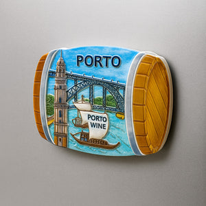 Decorative magnet of a wine barrel with Porto-themed design on a gray background