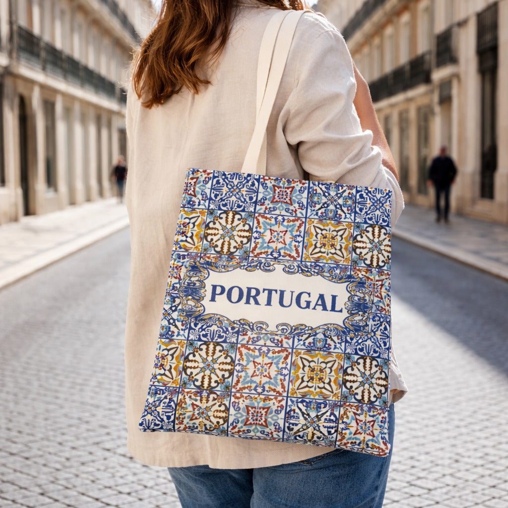 Portugal souvenir tote bag with traditional azulejos tile design displayed on wooden table.