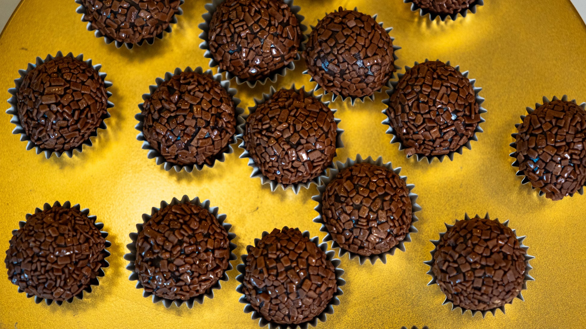 Close-up of traditional Portugal brigadeiro chocolate truffles with chocolate sprinkles in paper molds