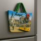 Fridge magnet with a design of a tram and architectural elements, labeled 'Portugal', on a metallic surface.