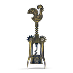 A bronze corkscrew with intricate details is shown. The handle, shaped like the Barcelos Rooster—a symbol often associated with Portugal—features a heart design. The midsection also displays the word "Portugal." This charming souvenir has two levers and a turning mechanism.