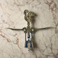 This intricately detailed bronze corkscrew features a handle shaped like the Barcelos Rooster, a beloved Portuguese symbol. The handle incorporates a heart design, and "Portugal" is prominently displayed on the midsection. The corkscrew is complete with two levers and a twist mechanism.