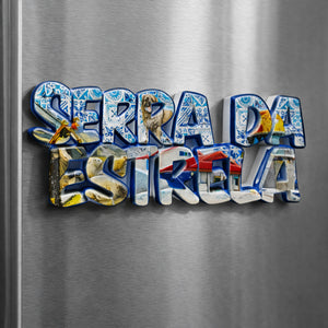 Serra da Estrela Portugal souvenir magnet placed on a fridge with typographic design, azulejo-style patterns, sheep imagery, and mountain village elements