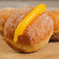 Traditional Portuguese Bola de Berlim doughnuts with sugar coating and creamy filling