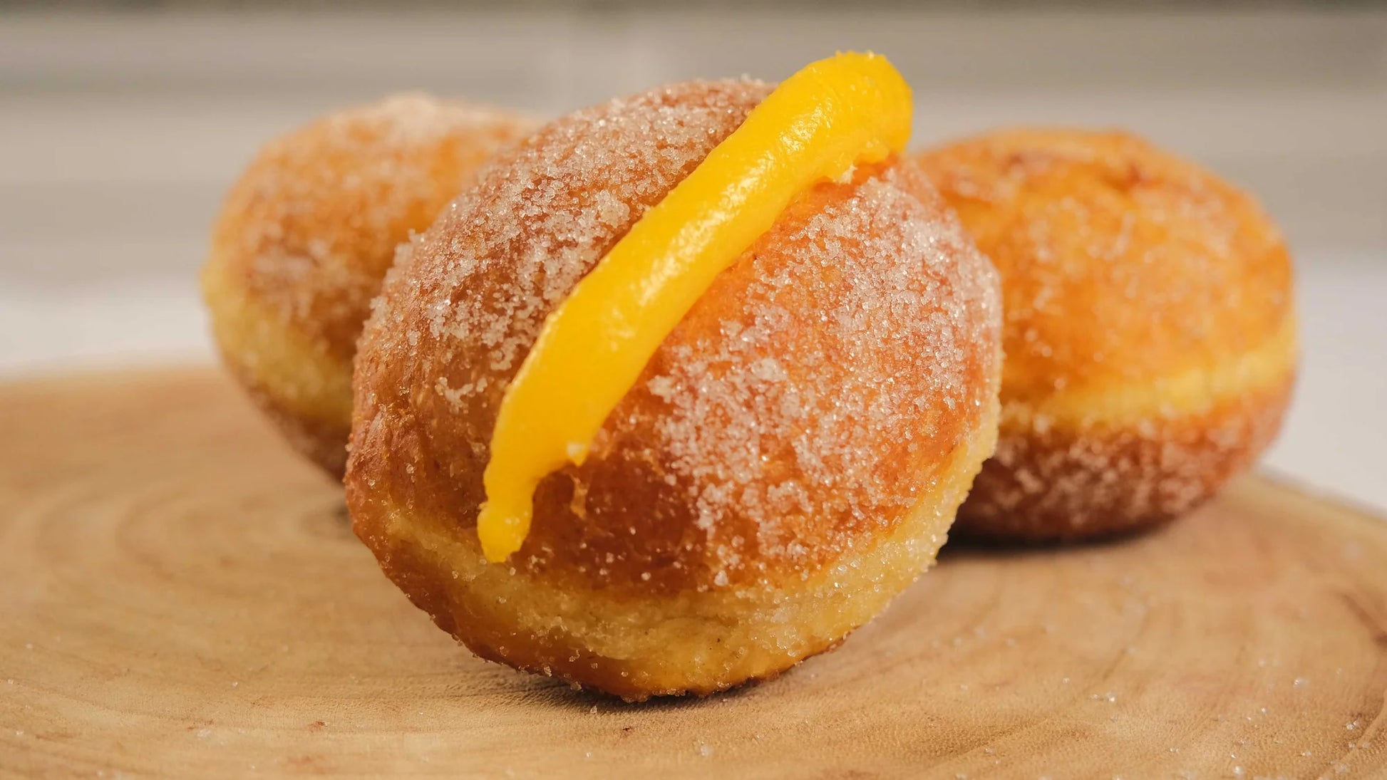 Traditional Portuguese Bola de Berlim doughnuts with sugar coating and creamy filling