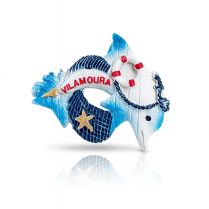 Magnet featuring a blue and white dolphin wrapped around a lifebuoy with red accents, the word “Vilamoura” in red, and a golden starfish on a textured navy background